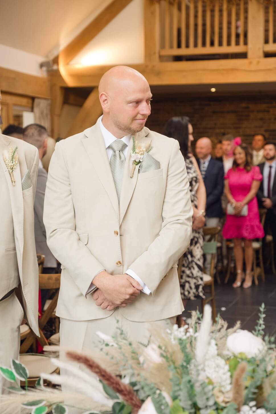 The groom waiting at the ceremony in the Oak Barn