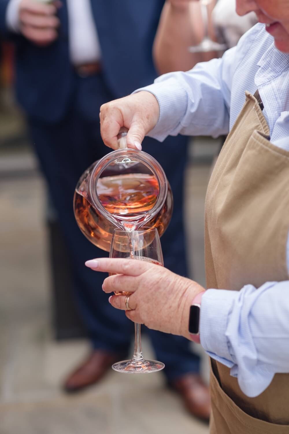 A waitress pouring drinks at the Mythe Barn reception