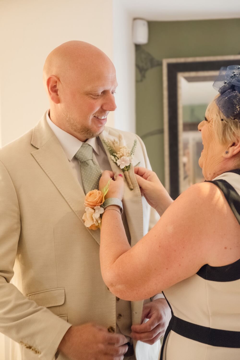 The groom having his buttonhole pinned on