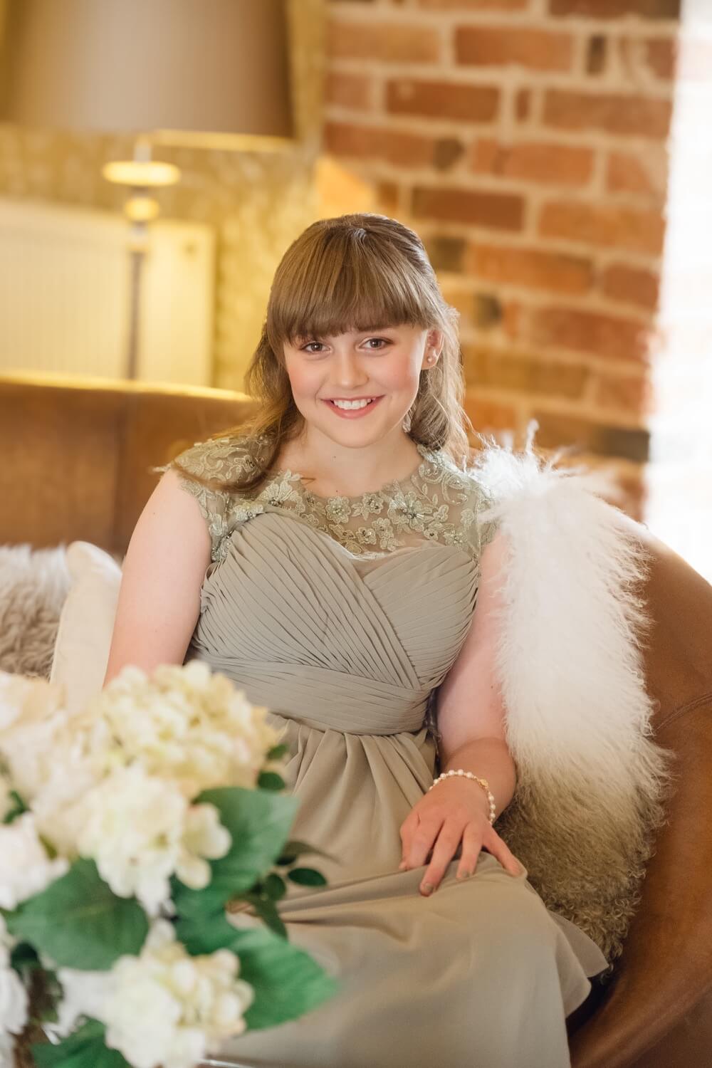 A bridesmaid smiling during getting ready