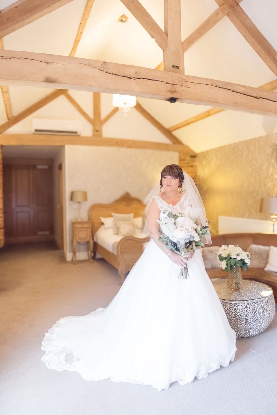 The bride in her dress and flowers at Mythe Barn