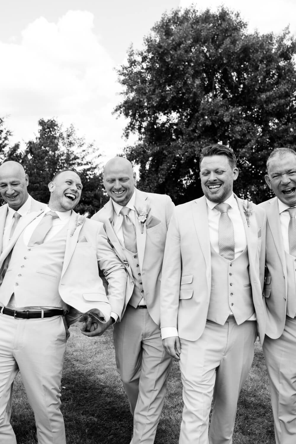The groom's party laughing together at Mythe Barn