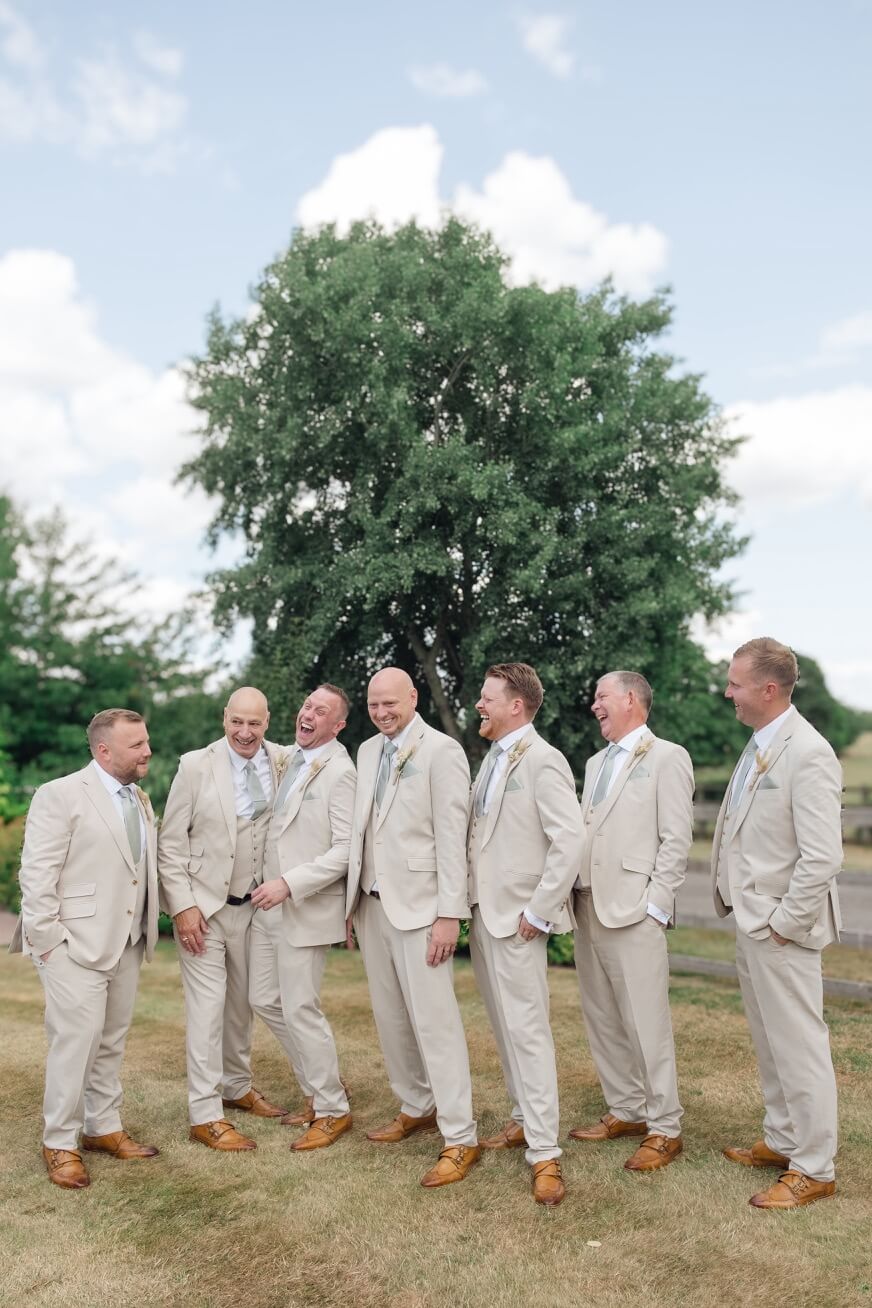 The groom with his groomsmen in the grounds