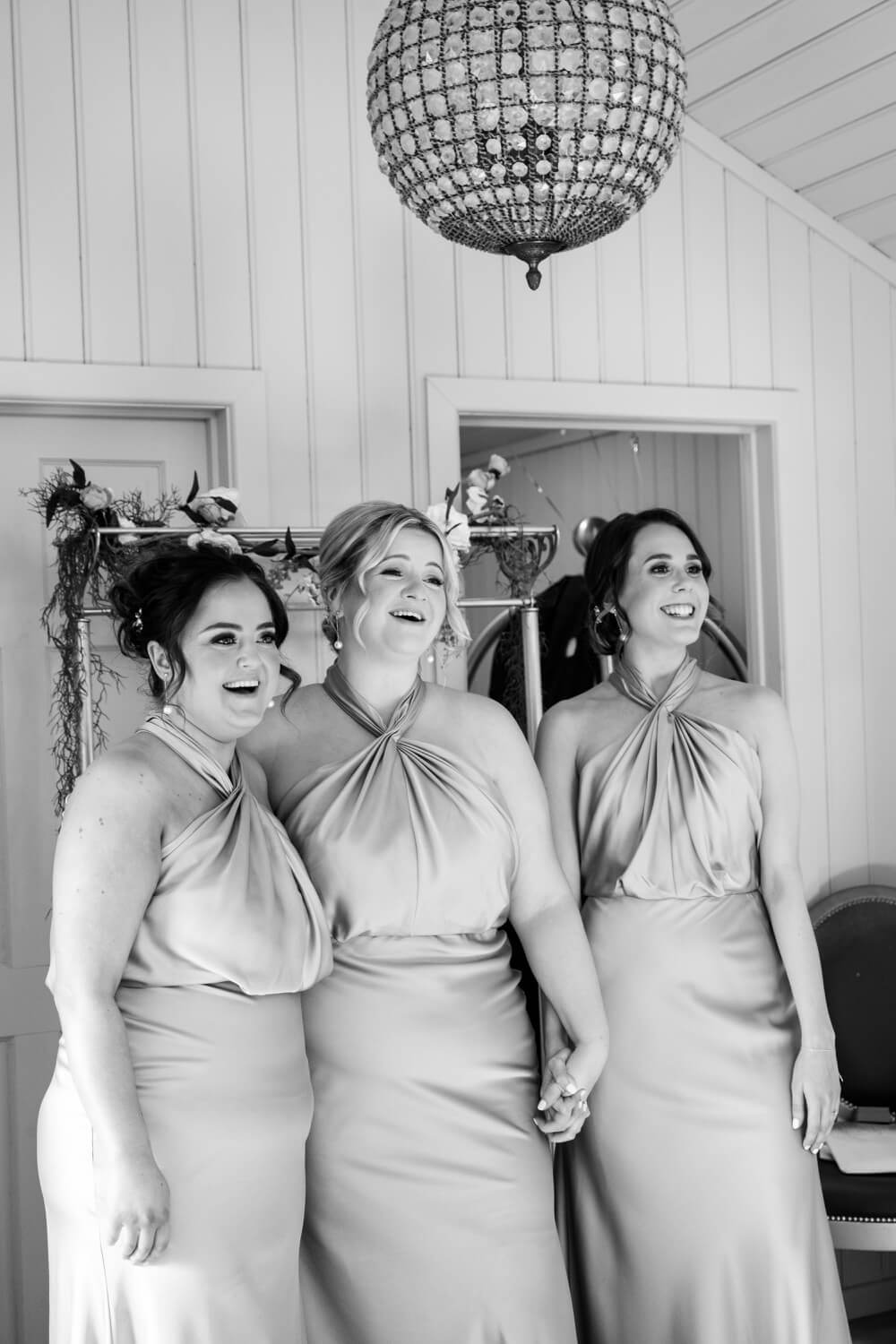 Bridesmaids seeing the bride in her dress for the first time