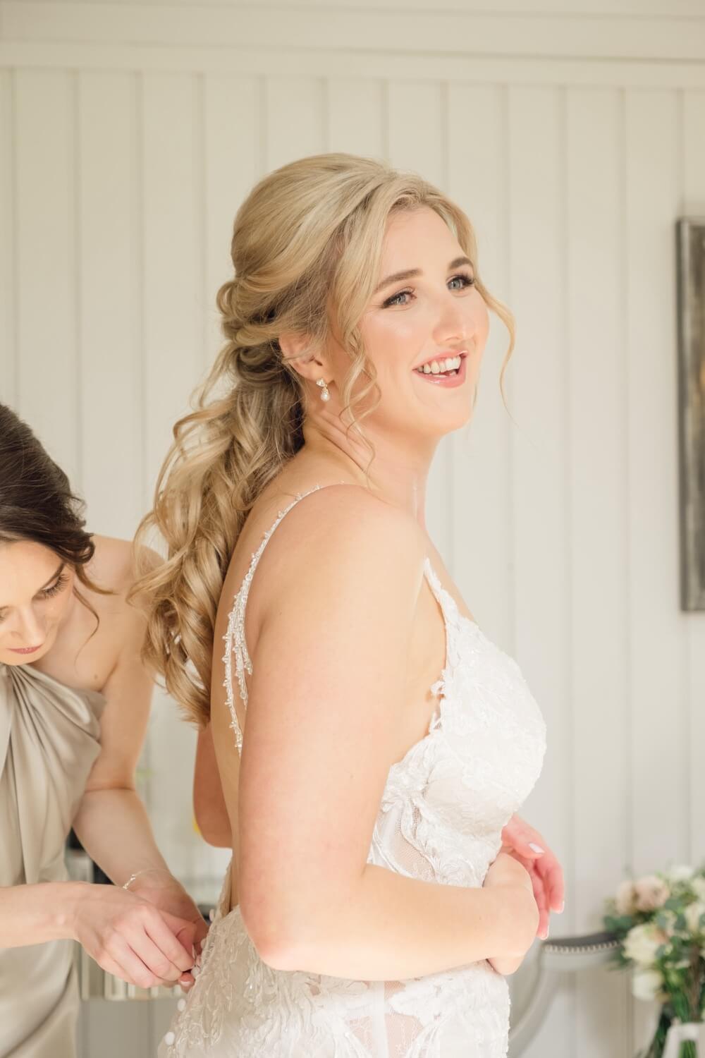Final touches to the bride's gown before the ceremony