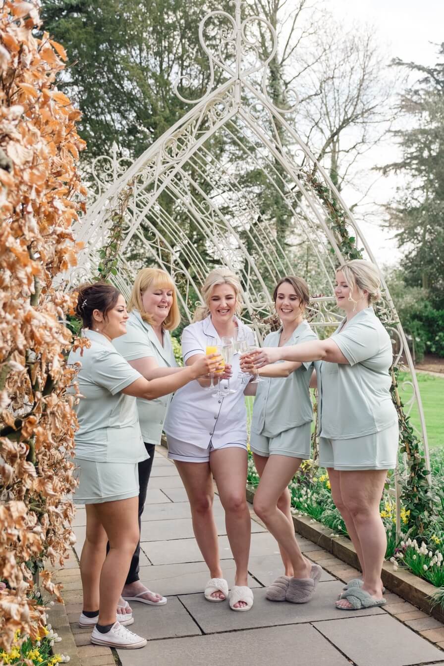 Bride and bridesmaids champagne toast before the Moxhull Hall wedding