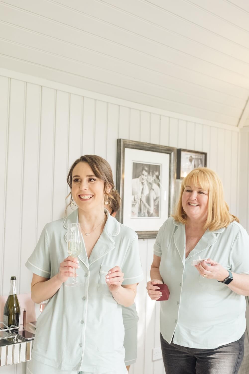 Bridesmaids toasting with champagne in matching pyjamas