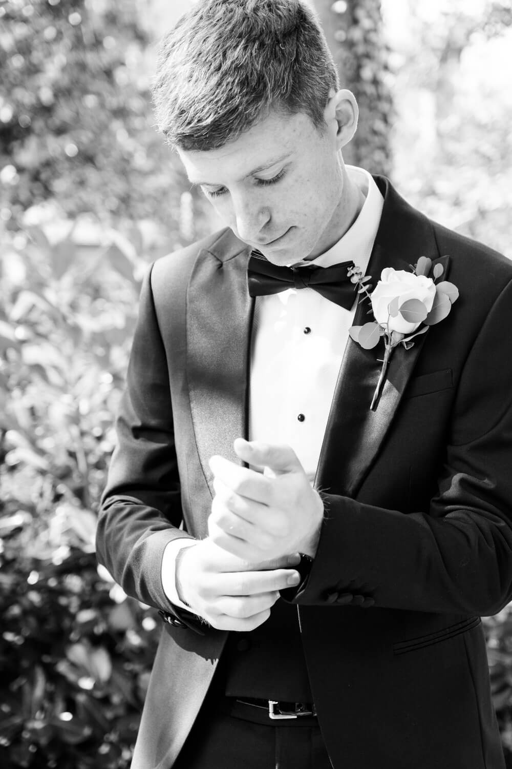 Groom fastening his cufflinks before the Moxhull Hall ceremony