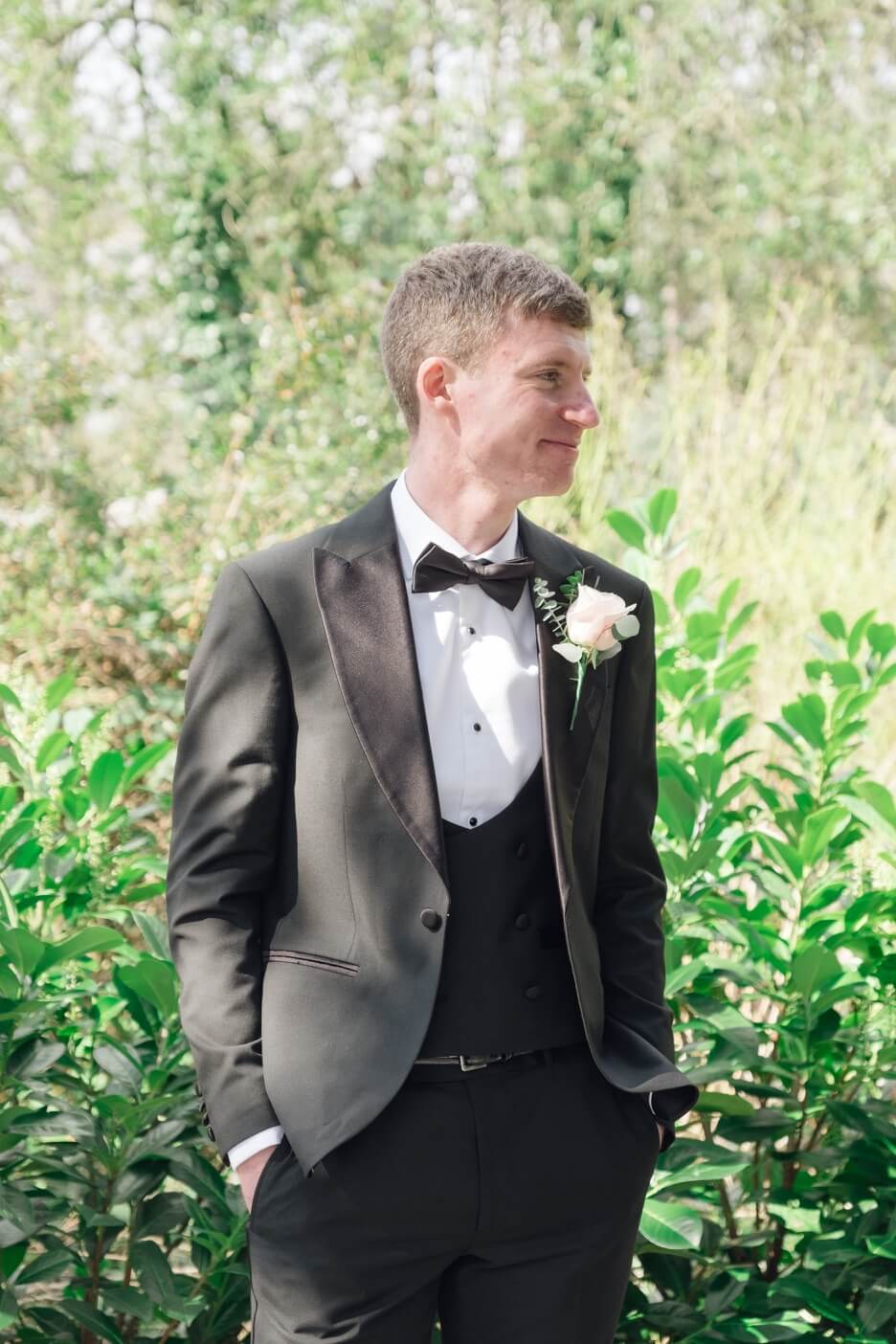 Groom smiling during preparations at Moxhull Hall