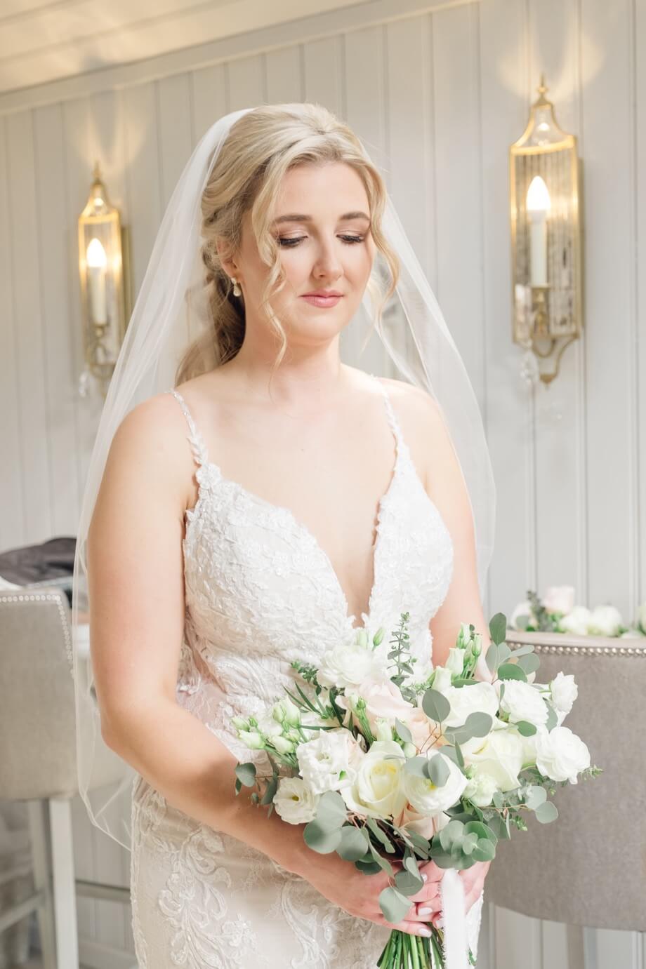 Quiet portrait of the bride, eyes lowered, before the ceremony