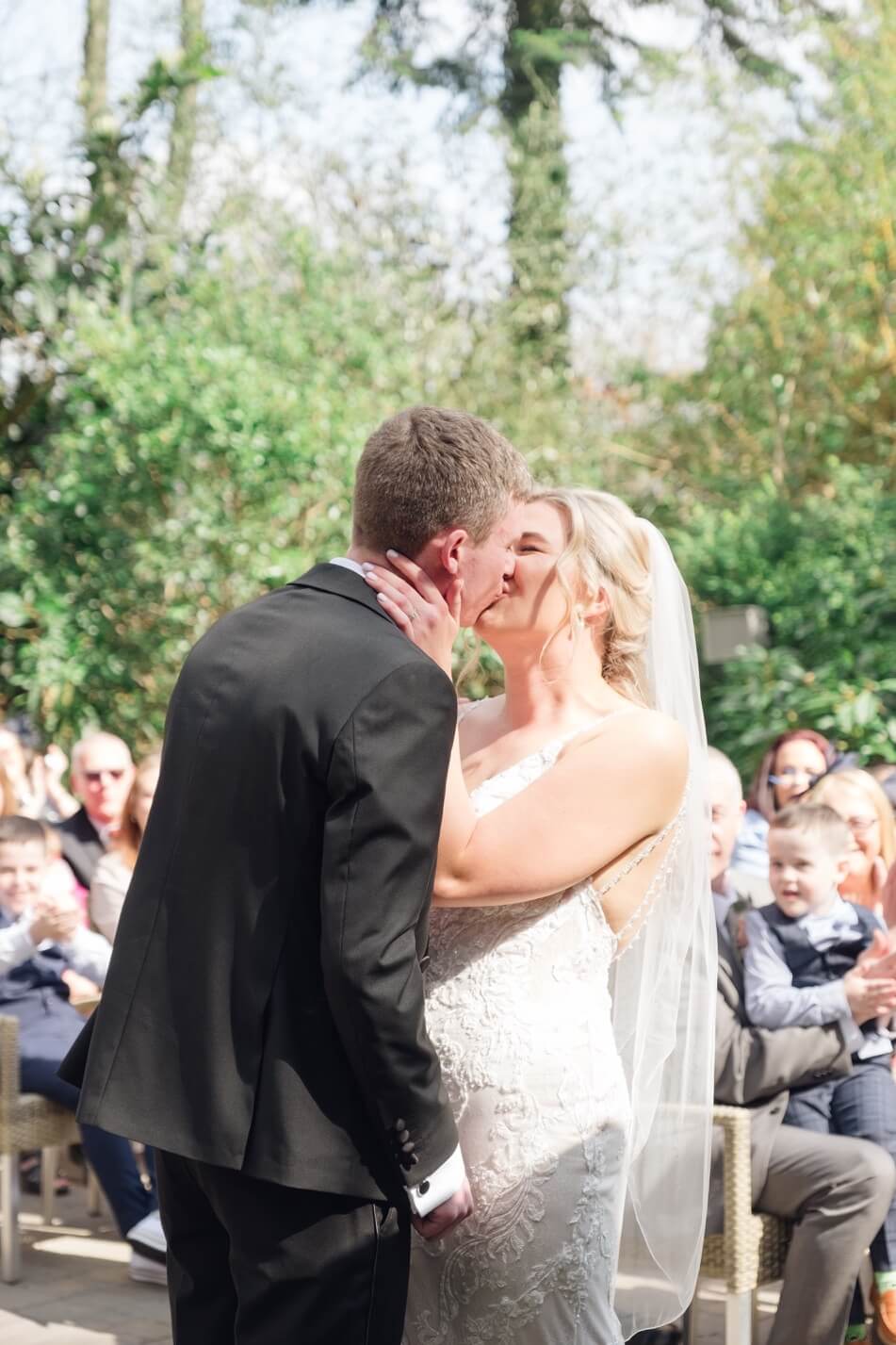 Newlyweds sharing their first kiss
