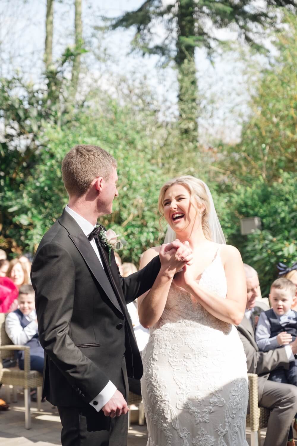 Bride laughing with the groom during the Moxhull Hall ceremony