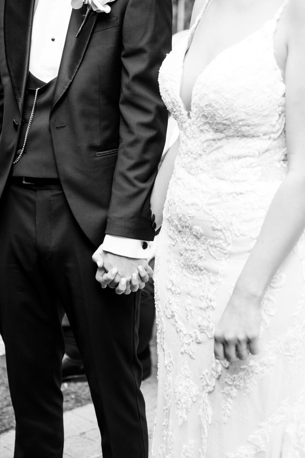 Bride and groom holding hands during the vows