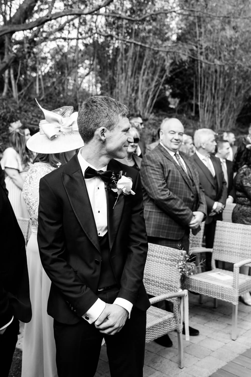Groom smiling as the bridal party enters