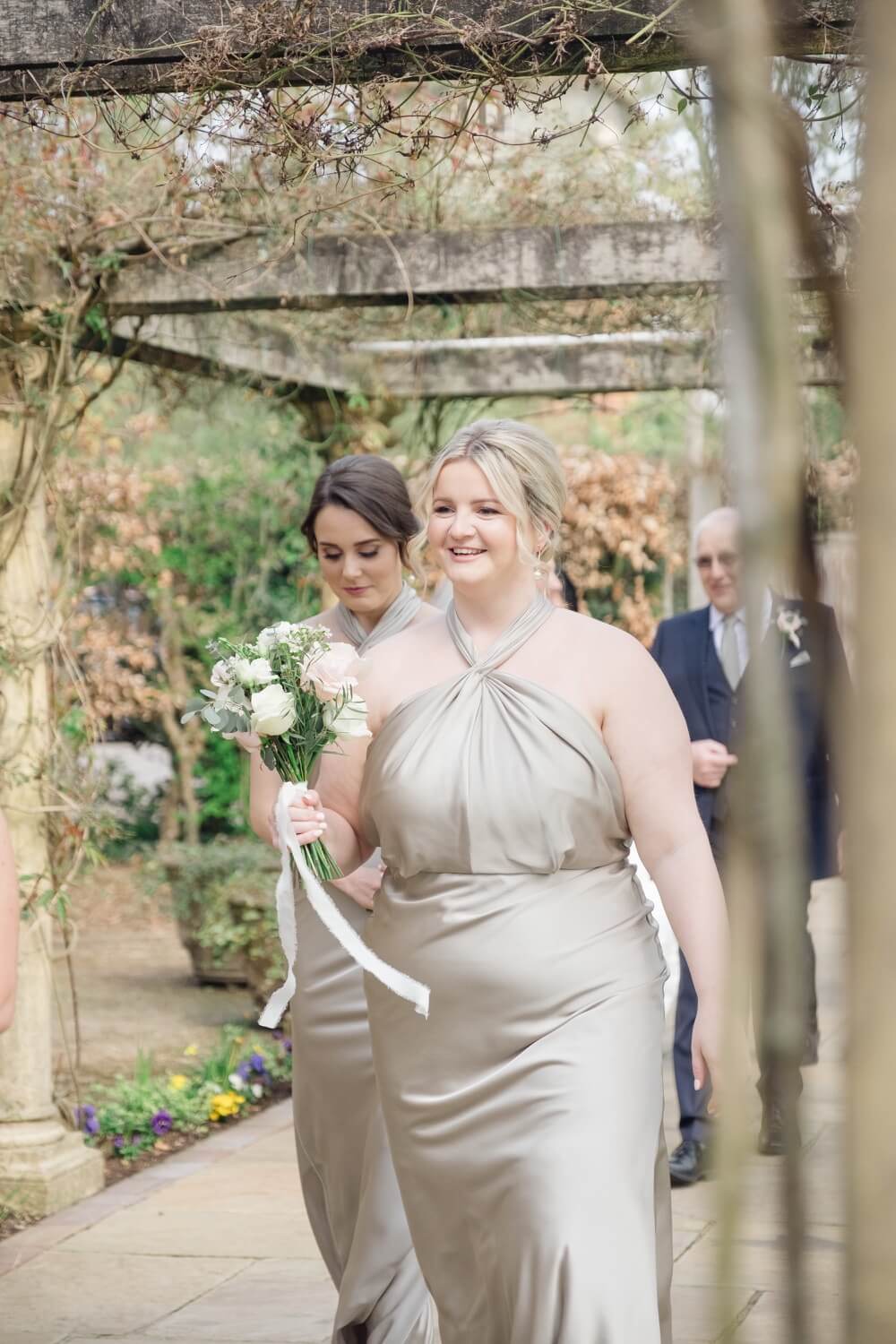 Bridesmaids walking towards the ceremony at Moxhull Hall