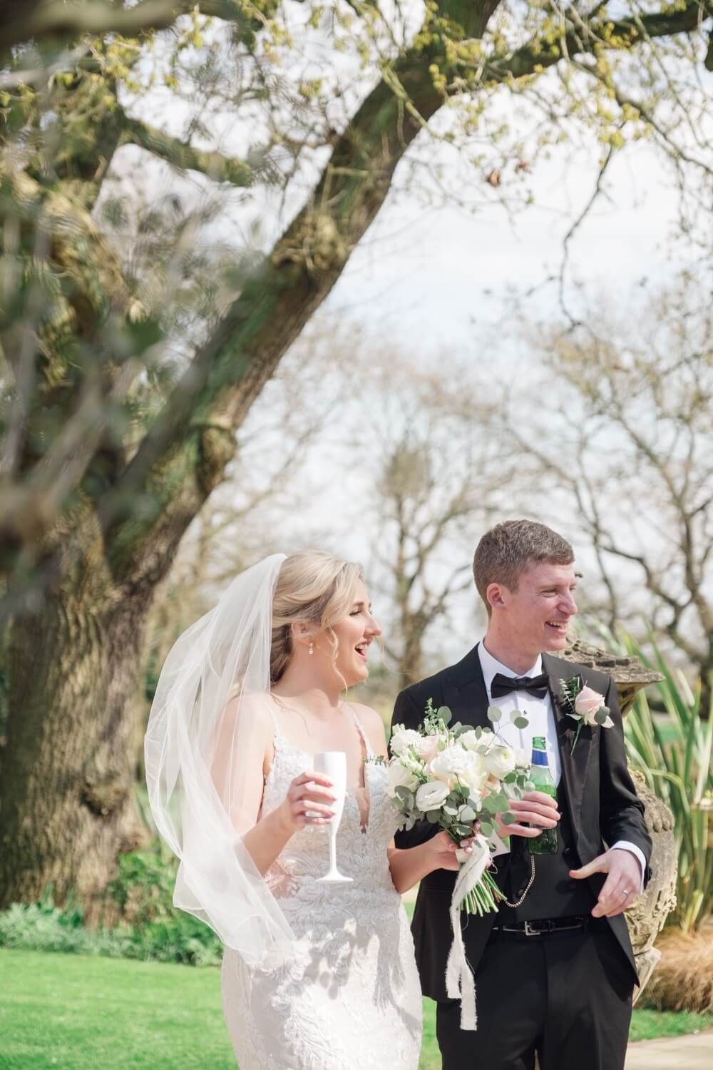 Candid moment between the bride and groom at the drinks reception