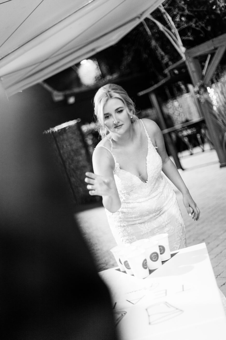 Bride playing beer pong at the evening reception