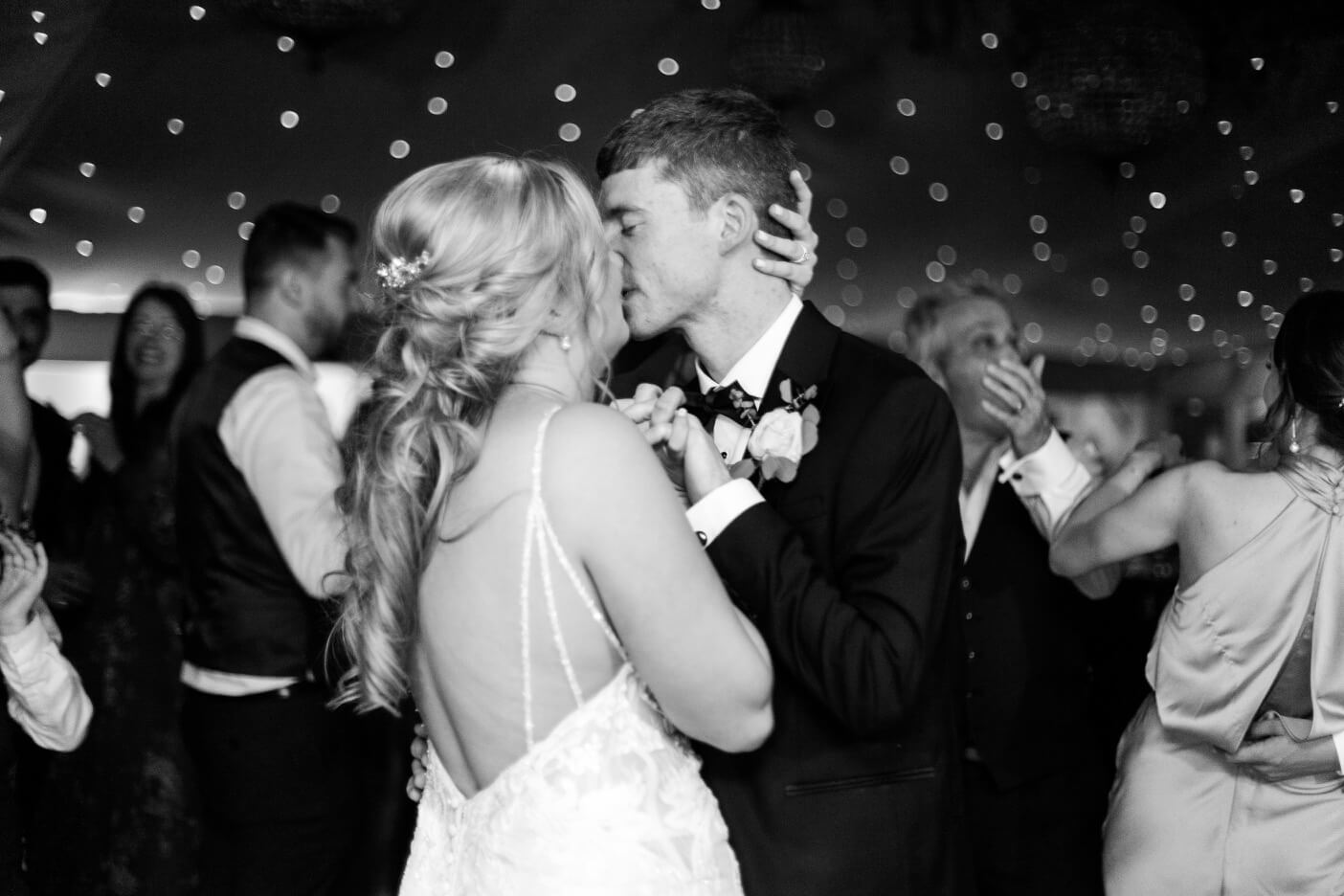Bride and groom kissing on the dance floor