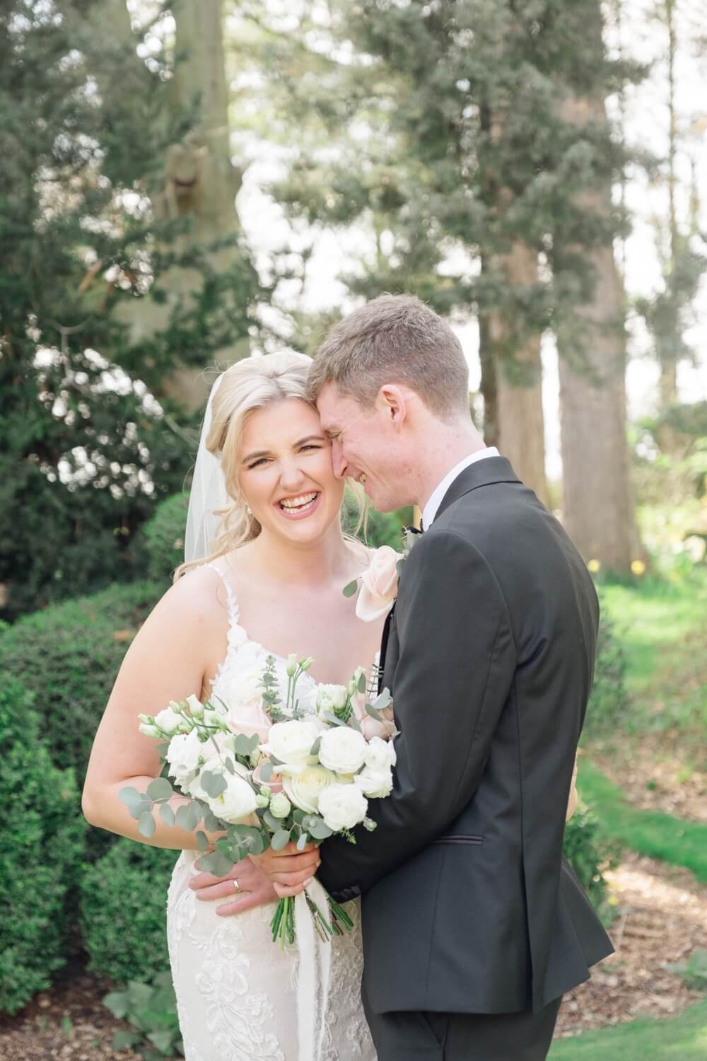 Bride laughing with the groom during portraits