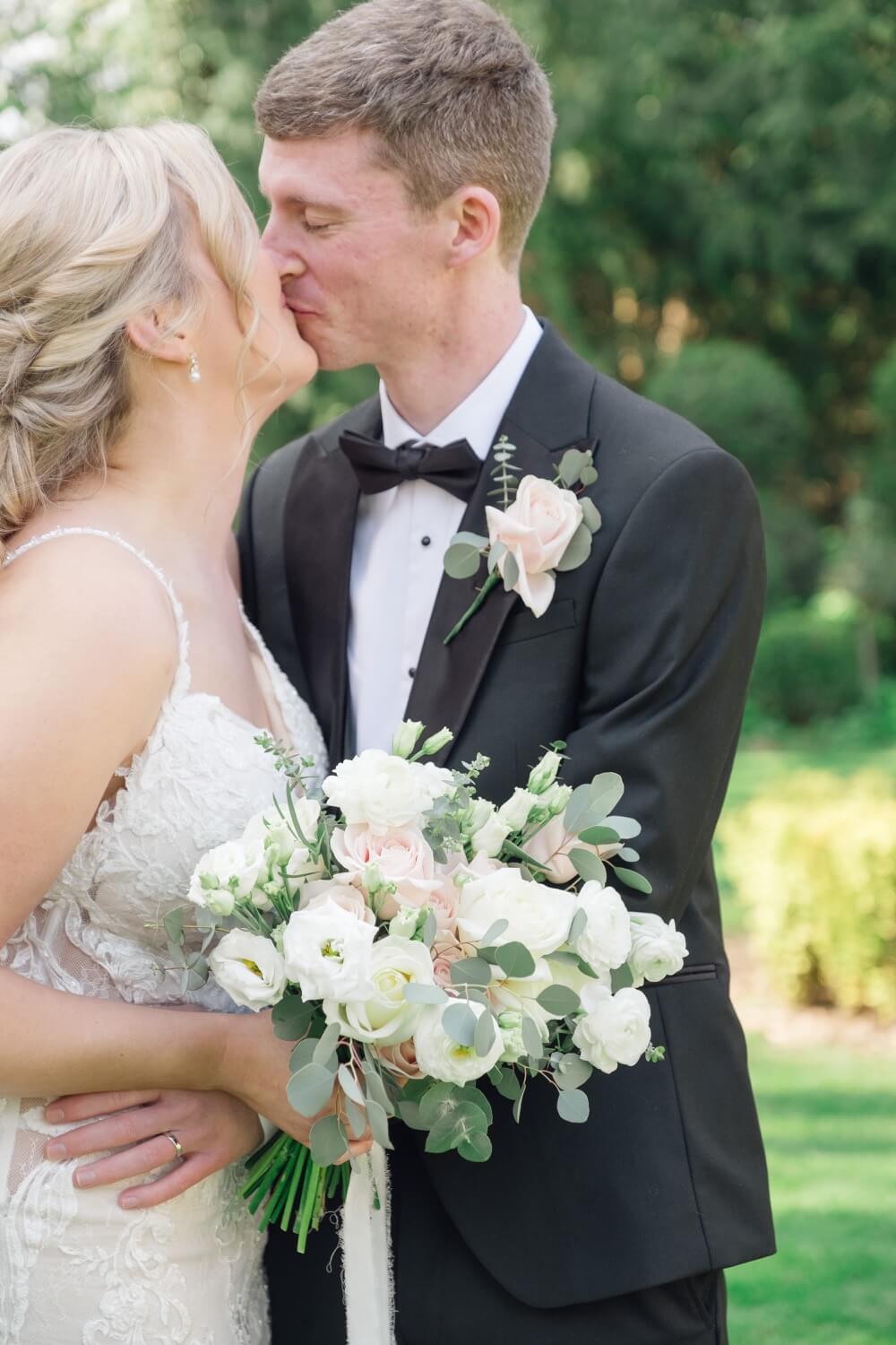 Groom kissing the bride during portraits