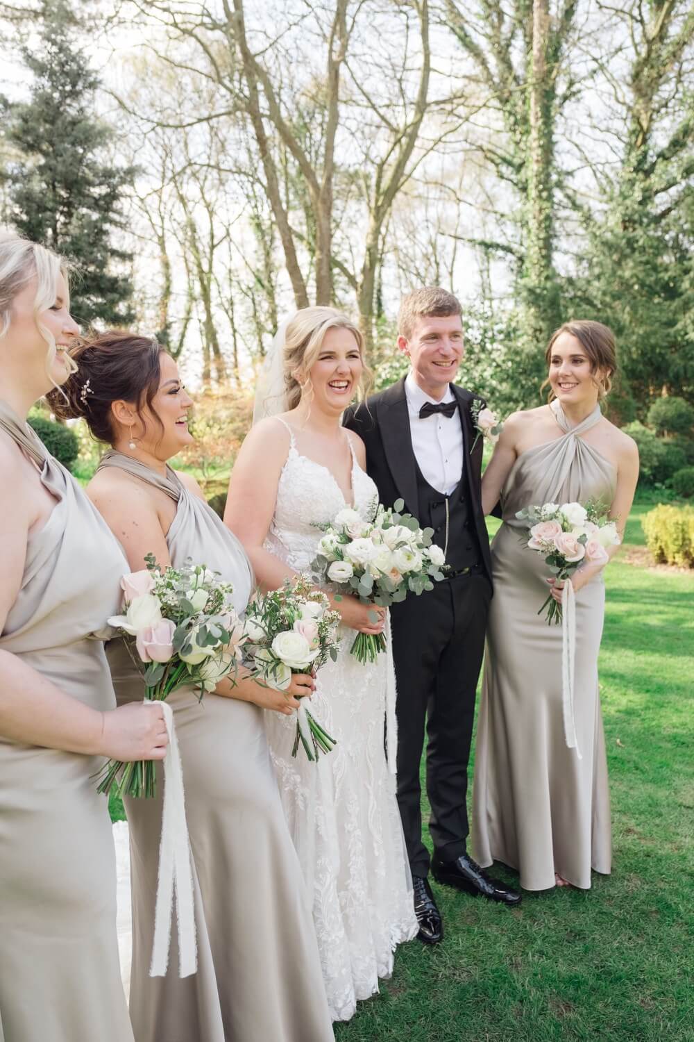 Bride laughing with the group at Moxhull Hall