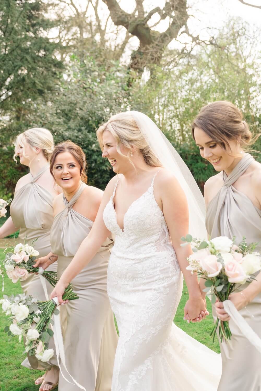 Bride walking with her bridesmaids in the grounds