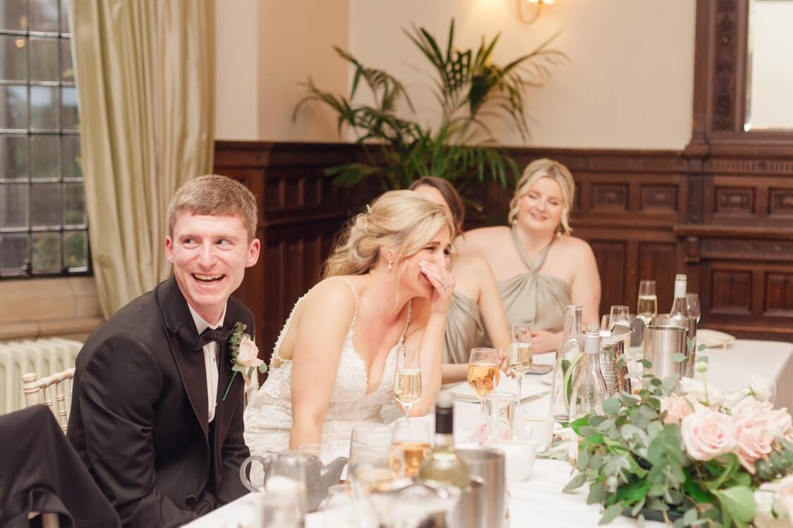 Bride laughing during the speeches at Moxhull Hall