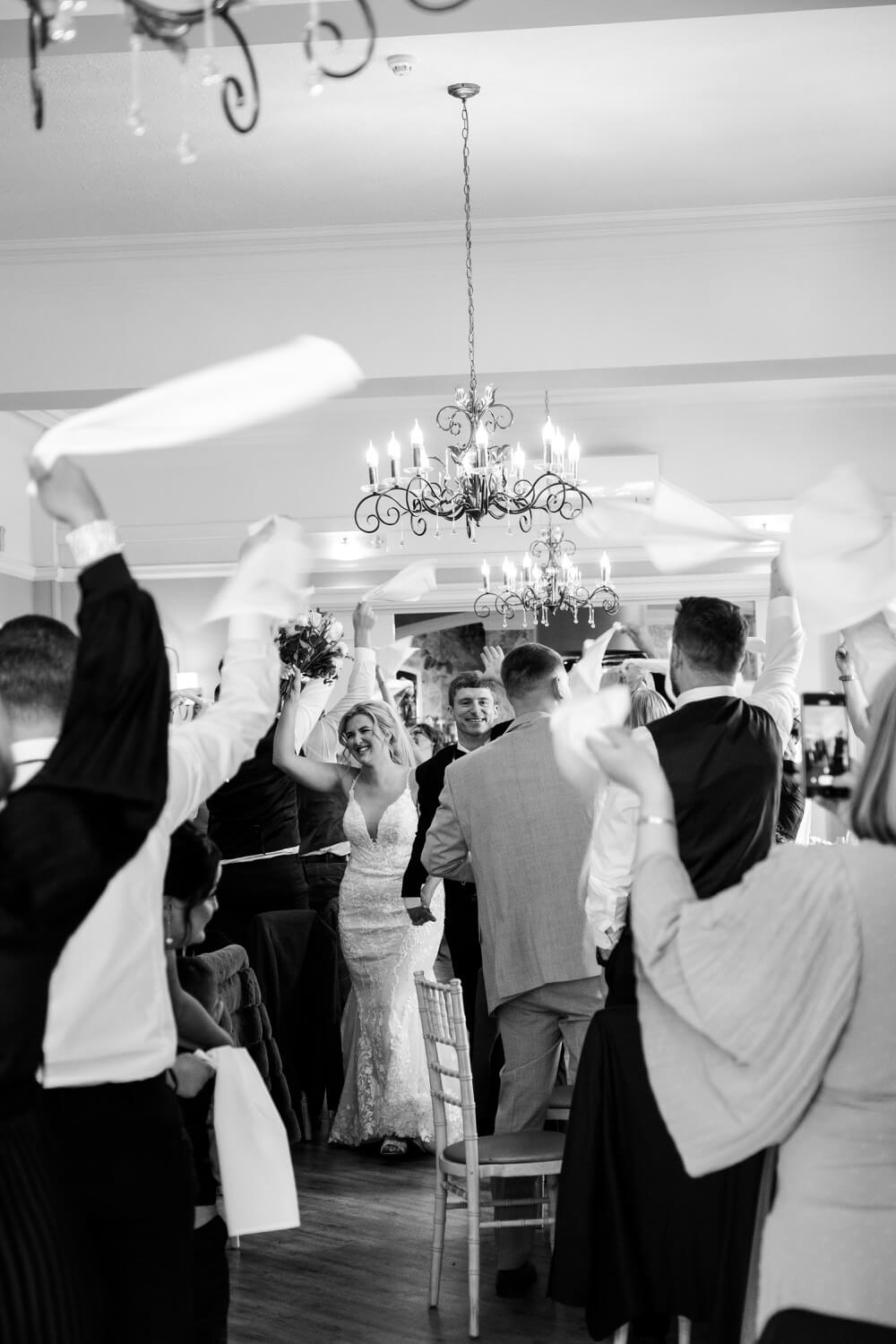Bride and groom's grand entrance into the Oak Hall at Moxhull Hall