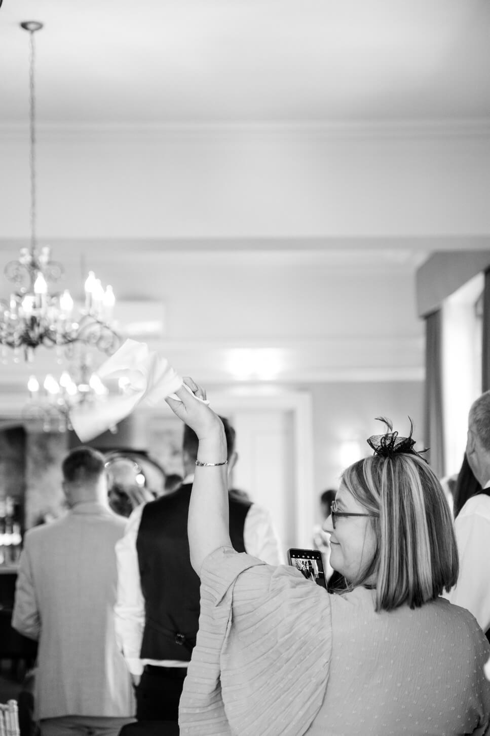 Guest waving a napkin as the couple enter