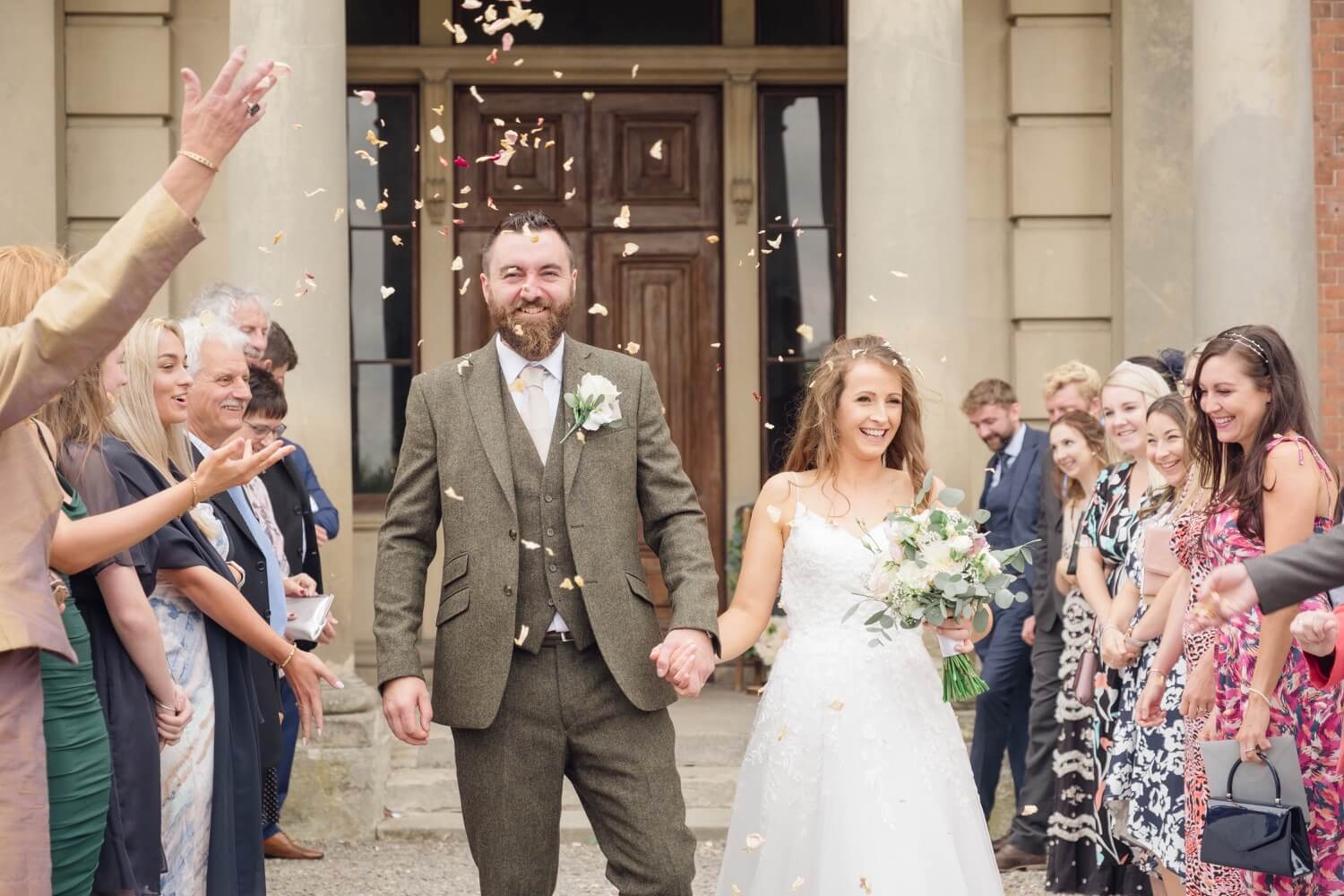 Annabelle and Matt walking through the confetti