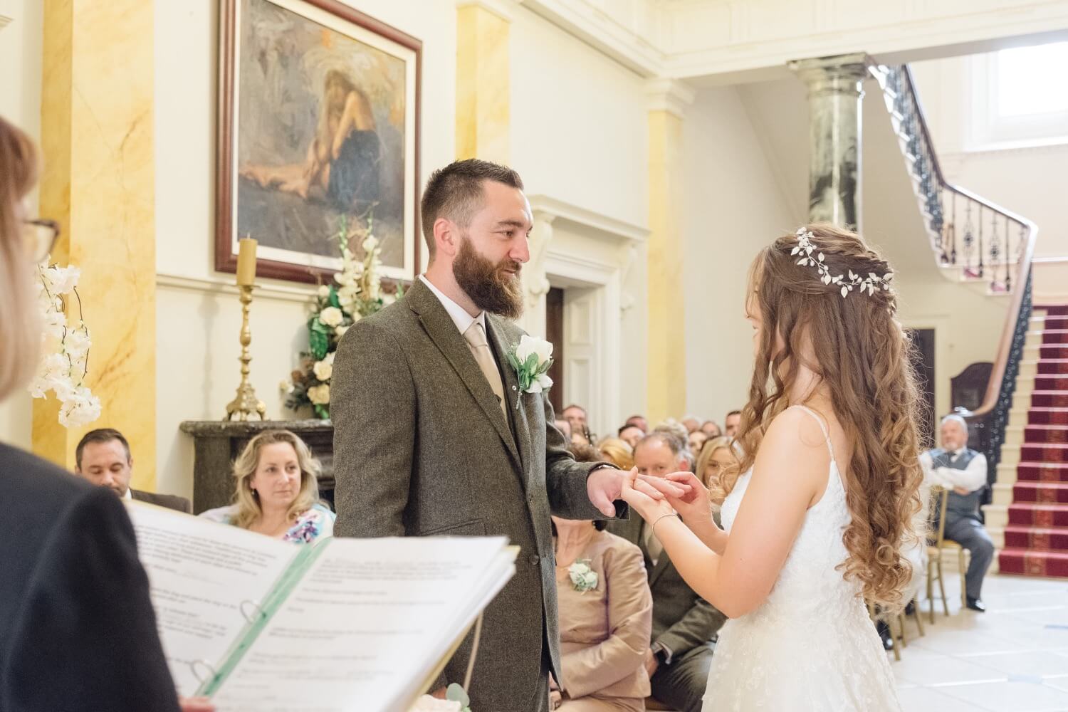 The ring going onto the groom's hand