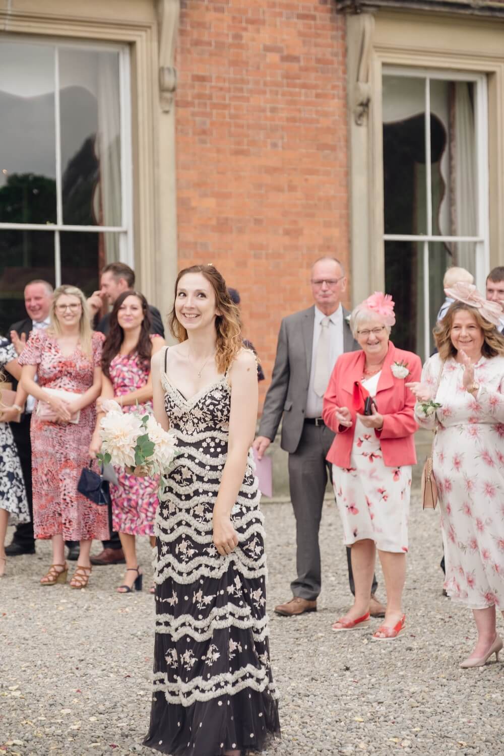 A guest catching the bouquet at Netley Hall