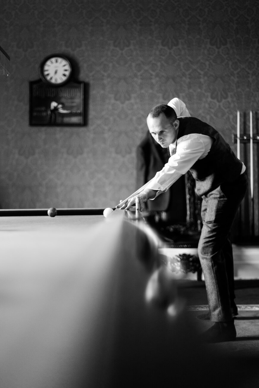 The best man at the snooker table before the ceremony