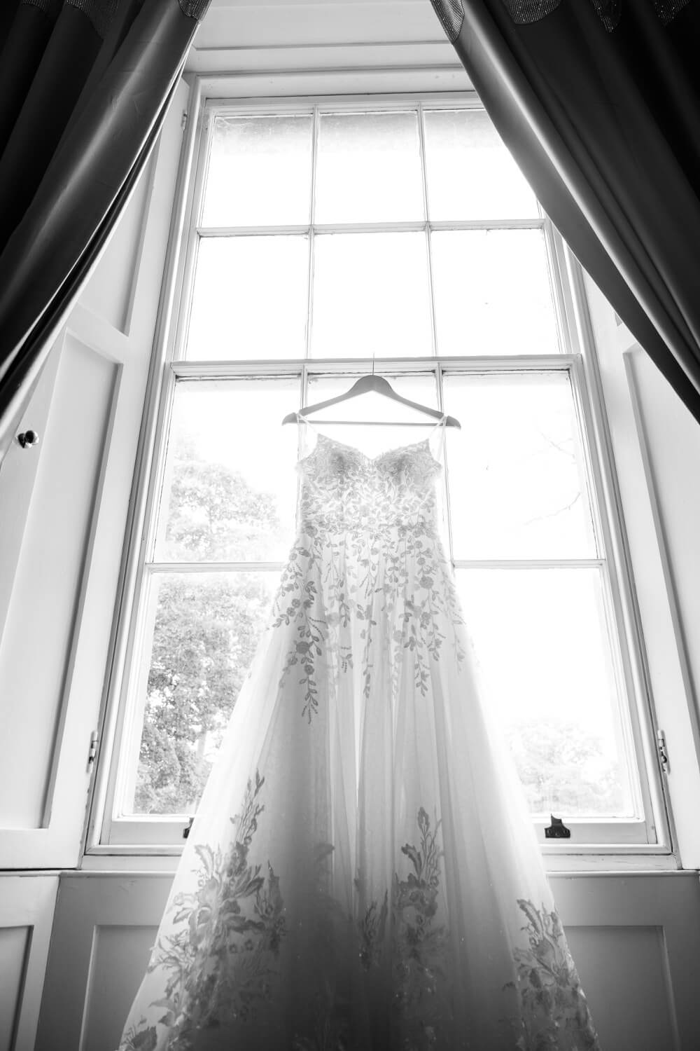 The wedding dress hanging in the window at Netley Hall