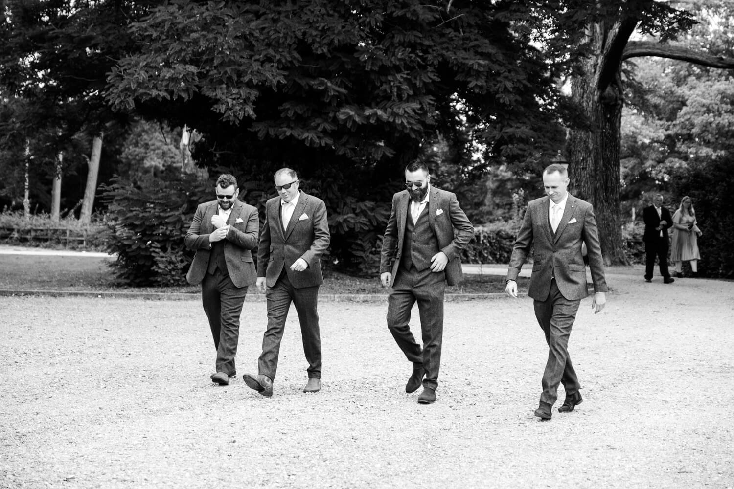 The groom and groomsmen walking the Netley Hall grounds