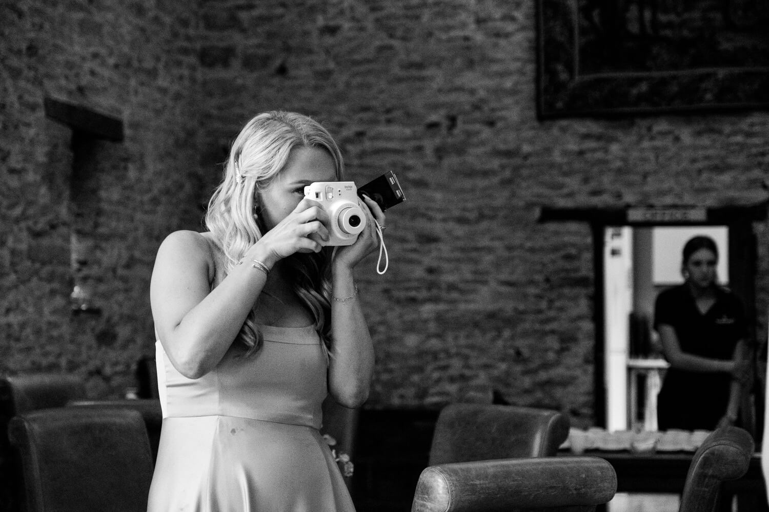Guest using a polaroid camera at The Great Barn, Aynho
