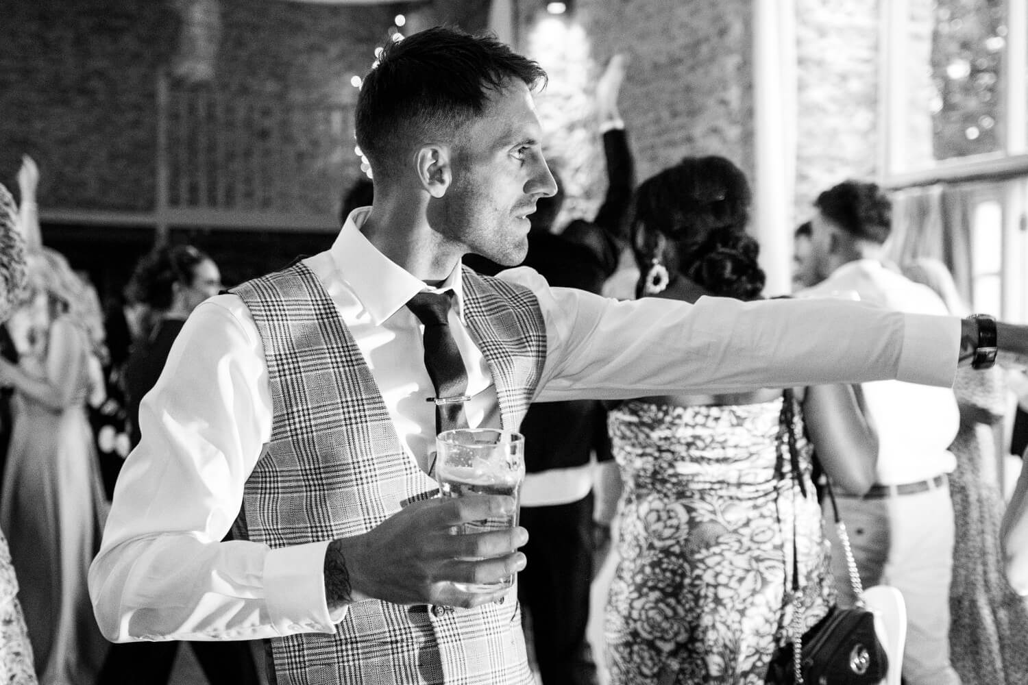 Guest dancing during the evening reception at The Great Barn, Aynho