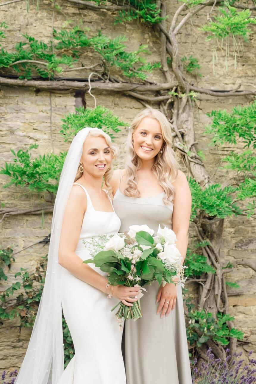 Bride with a bridesmaid at The Great Barn, Aynho