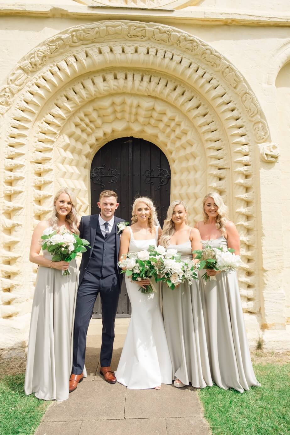 Bride and groom with the bridal party outside the church, Great Barn Aynho wedding
