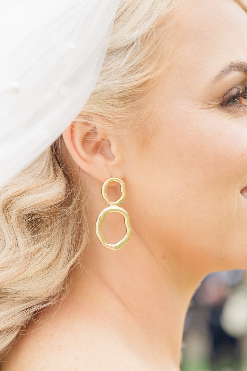 Detail of the bride's Alexander McQueen earring, Great Barn Aynho wedding