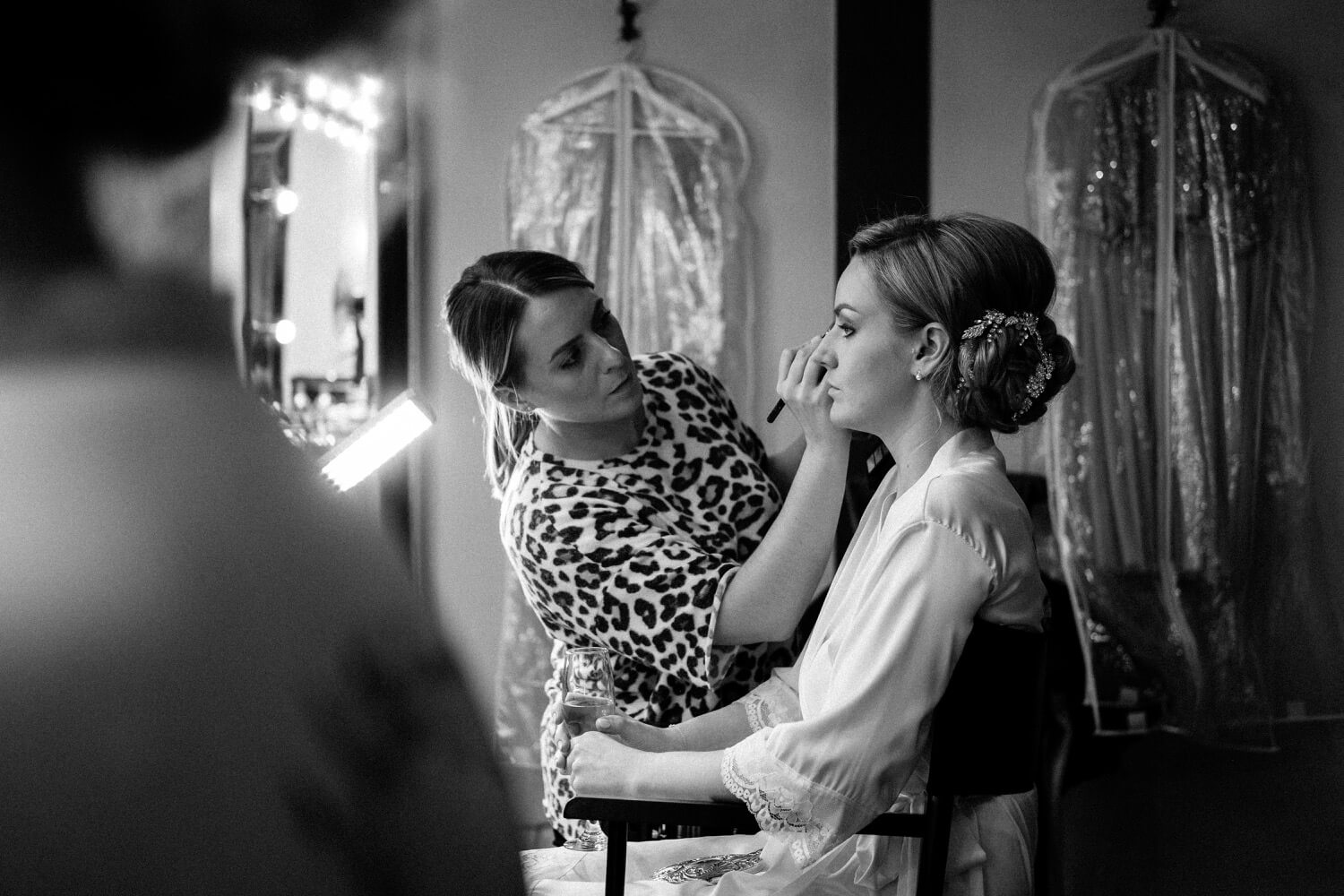 Bride's makeup being finished before the ceremony