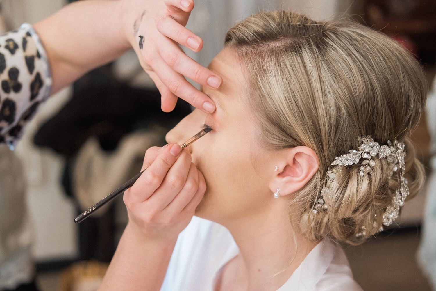 Bride's eye makeup being applied at The Mill Barns
