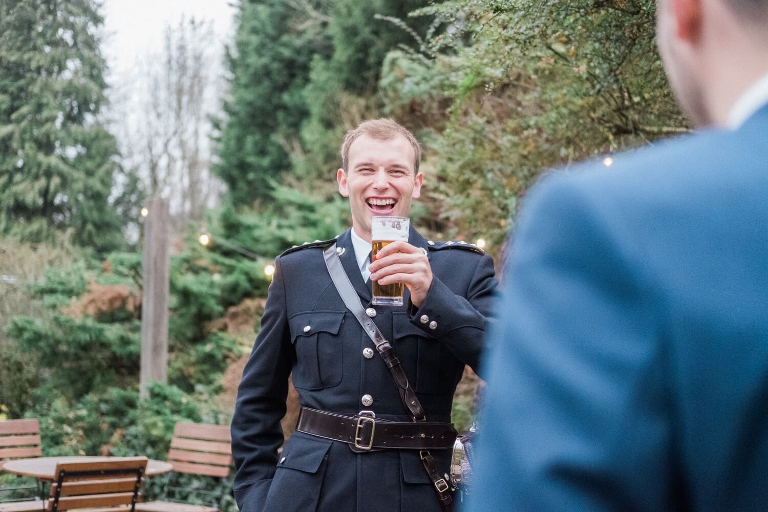 Best man having a beer and laughing before the ceremony