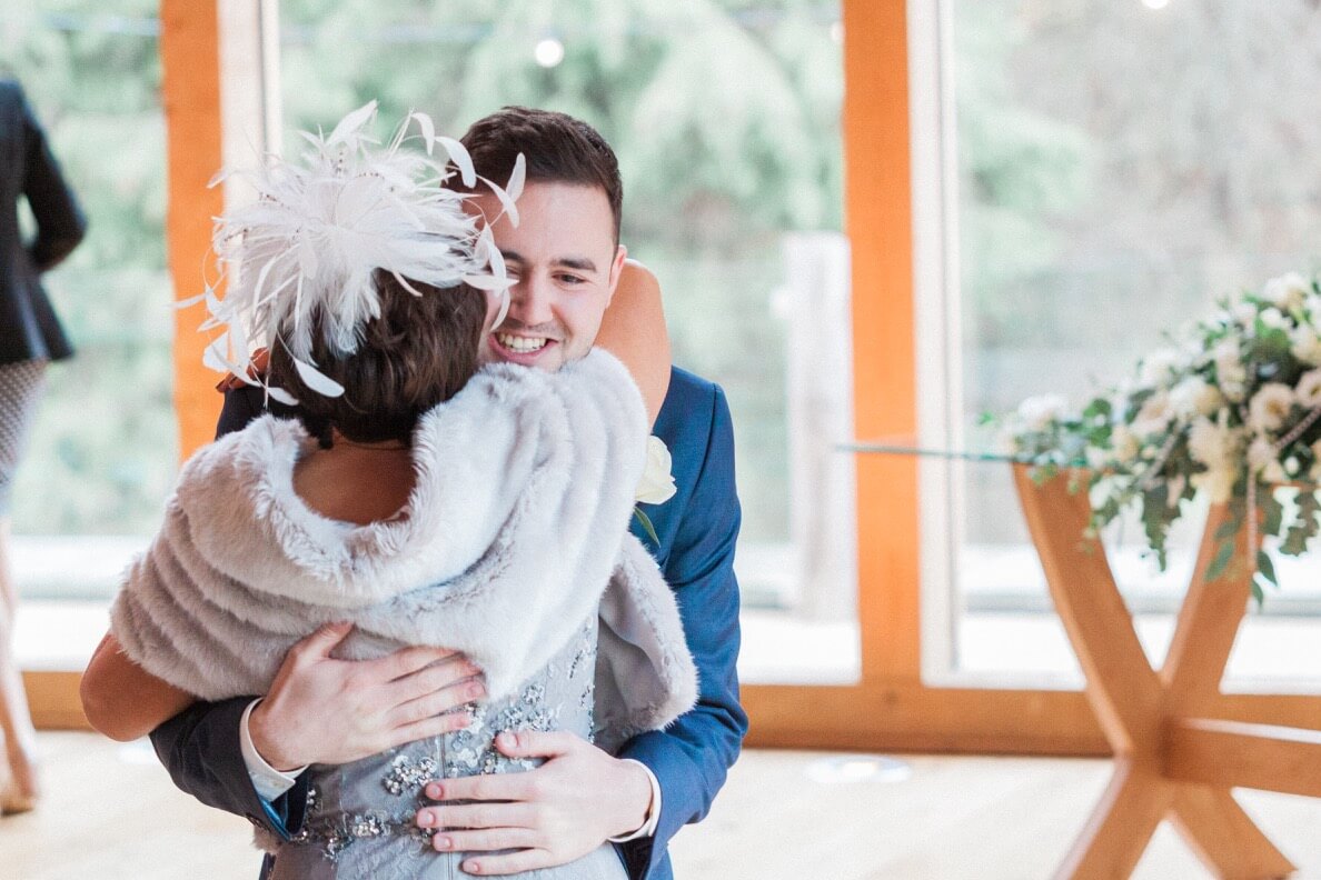 Groom hugging a guest at The Mill Barns