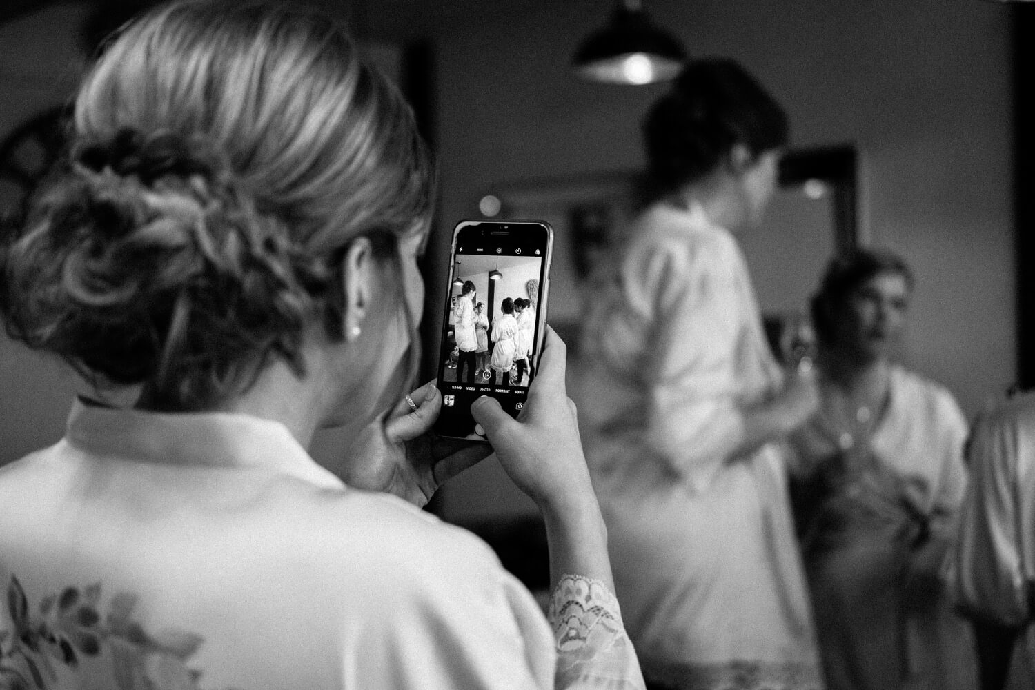 Bride photographing her bridesmaids in their pyjamas