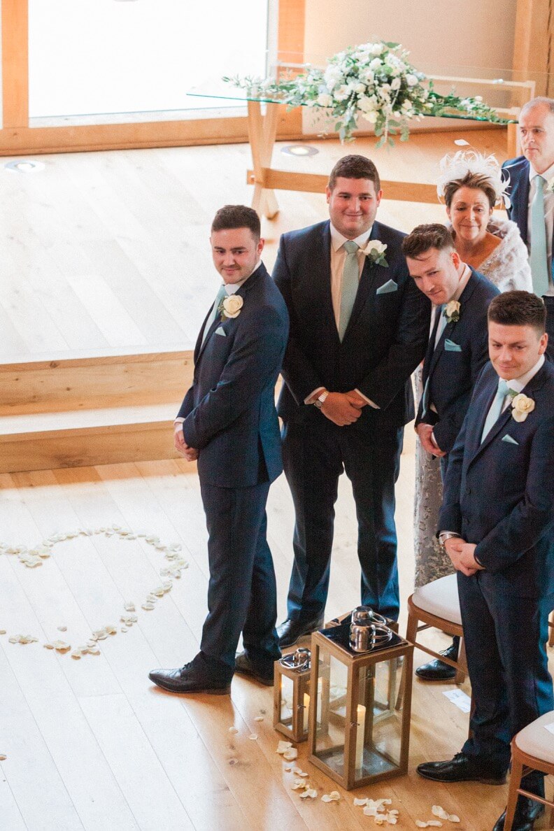 Groom turning to see the bride walk down the aisle