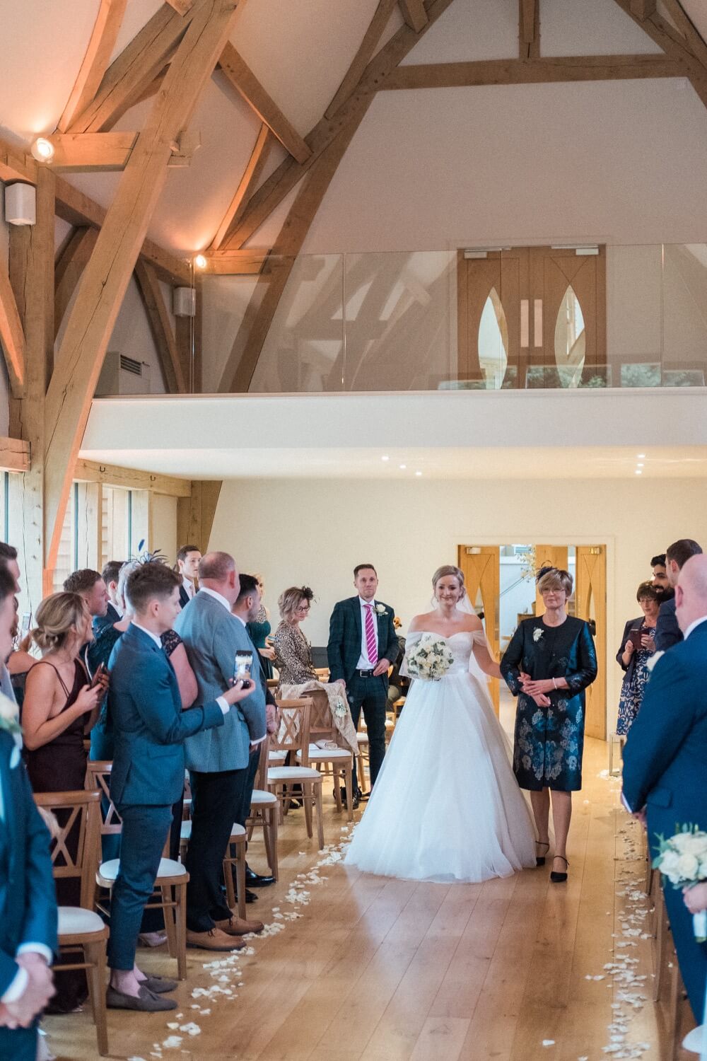 Bride walking down the aisle at The Mill Barns