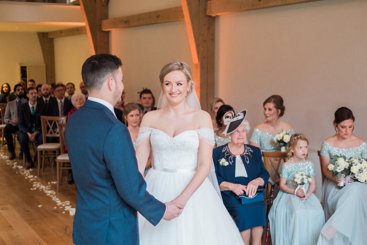 Bride holding the groom's hand during the ceremony