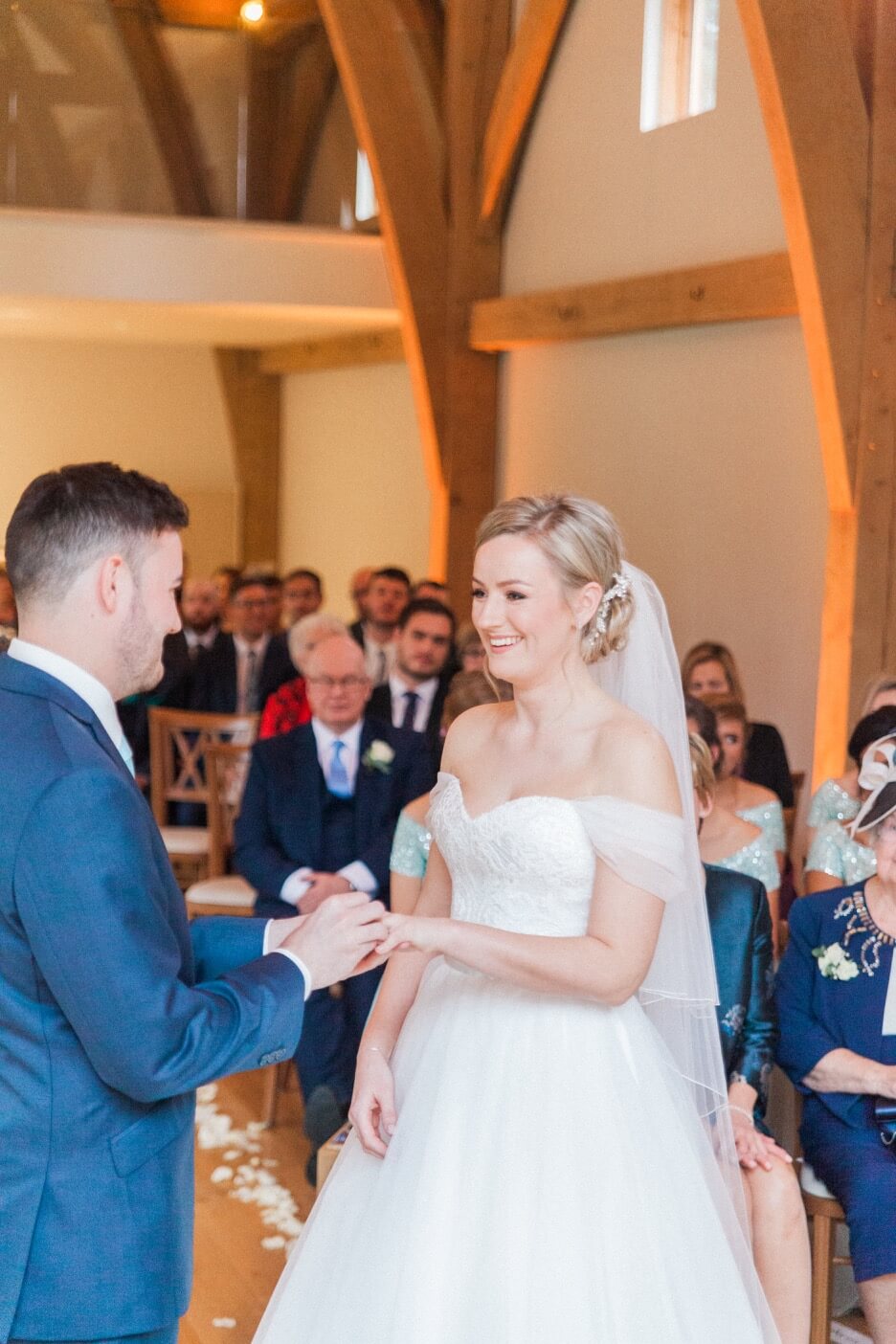 Groom placing the ring on the bride's hand