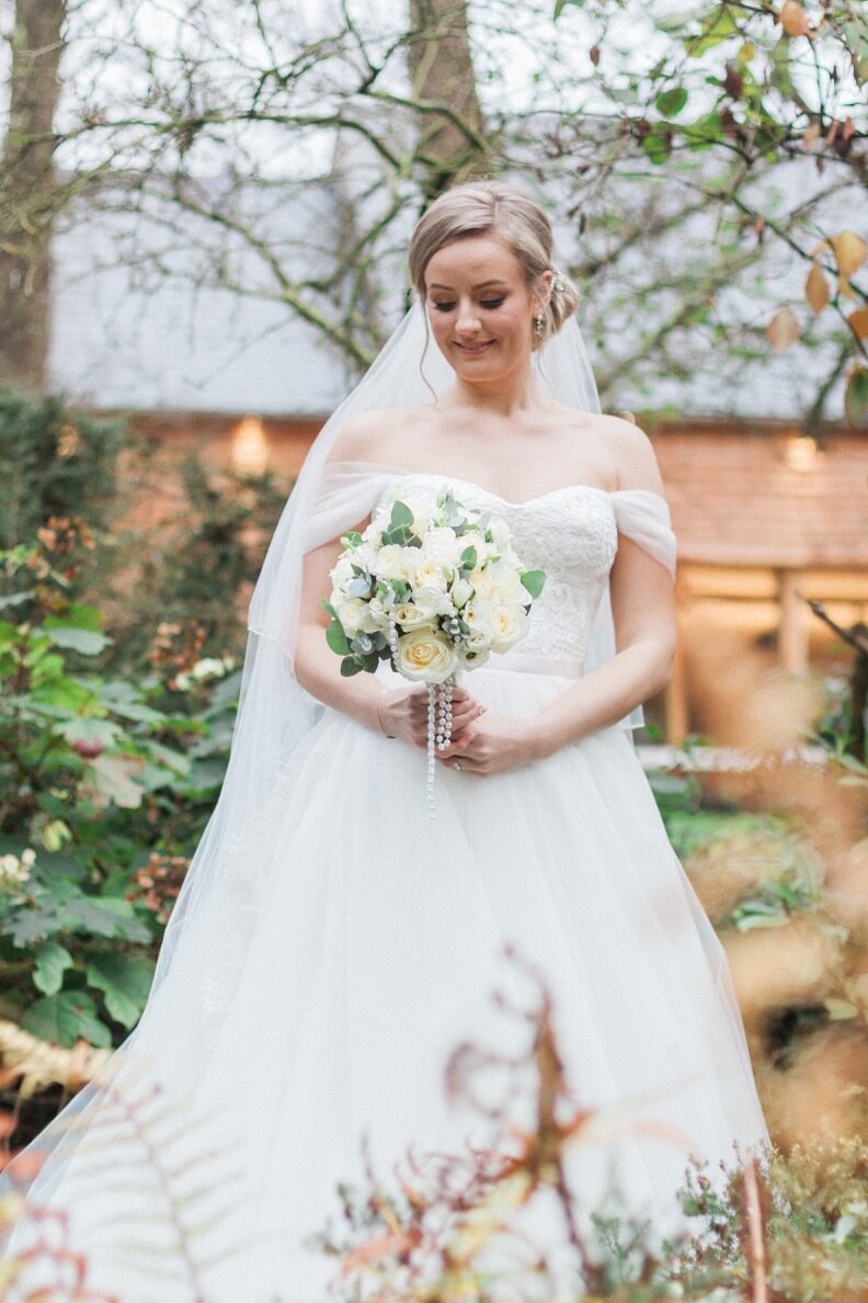 Bride portrait by the water at The Mill Barns